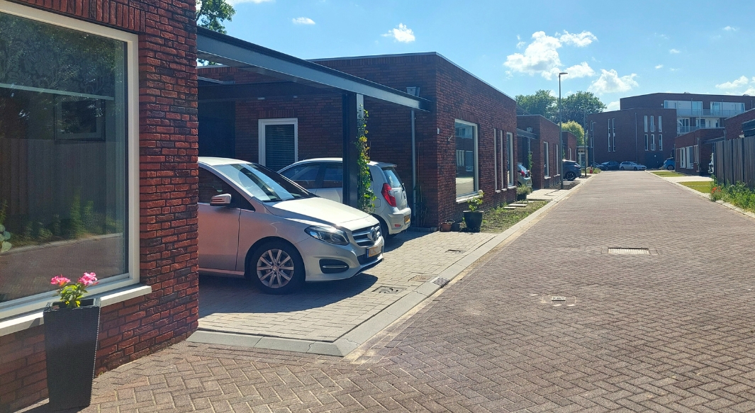 Zicht vanaf de patiowoningen met daarachter het appartementengebouw